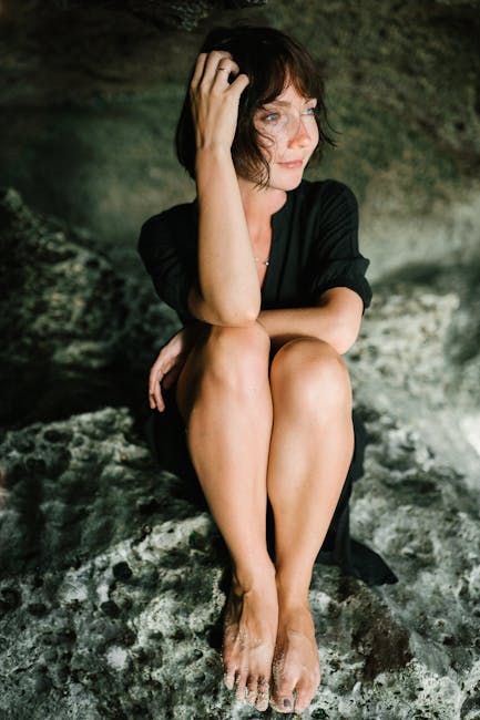 Woman sitting in a lotus position, calm and serene expression